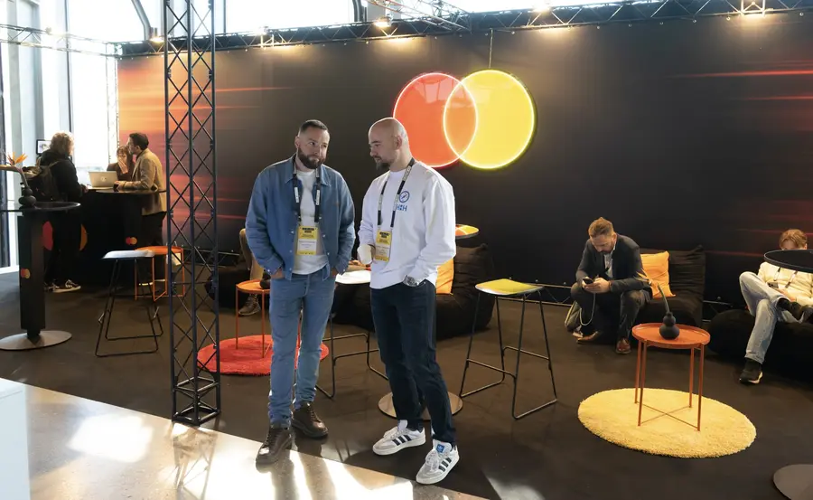 Attendees networking at a fintech industry event stand